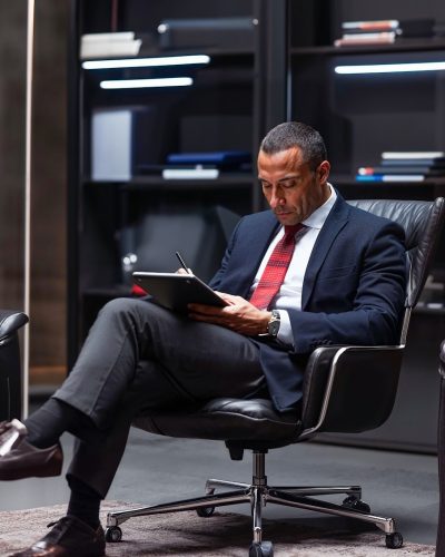 Man Working on Tablet in Modern Office
